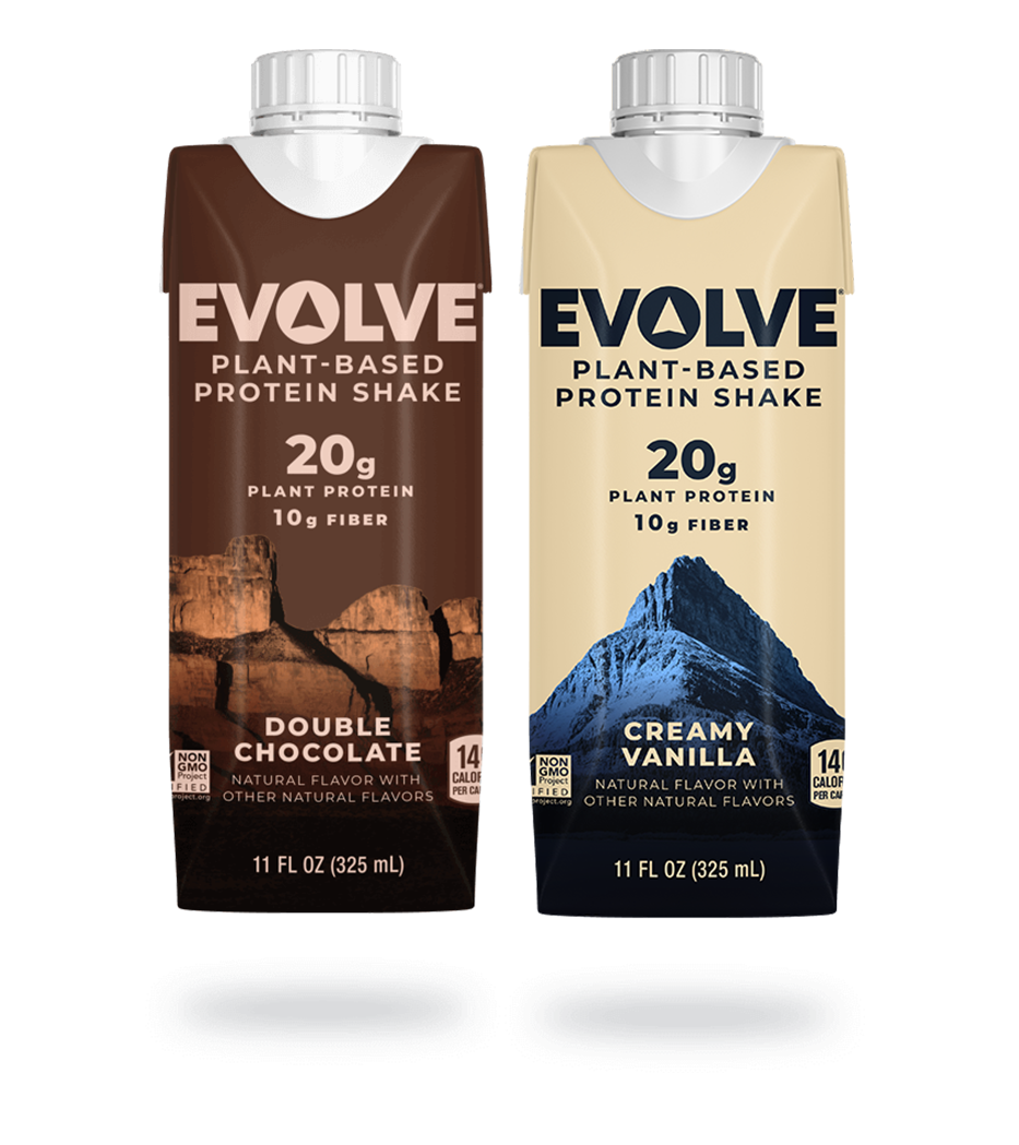 Three bottles of Evolve ready-to-drink protein shakes sit beside each other. Behind them, is an expansive mountain range.