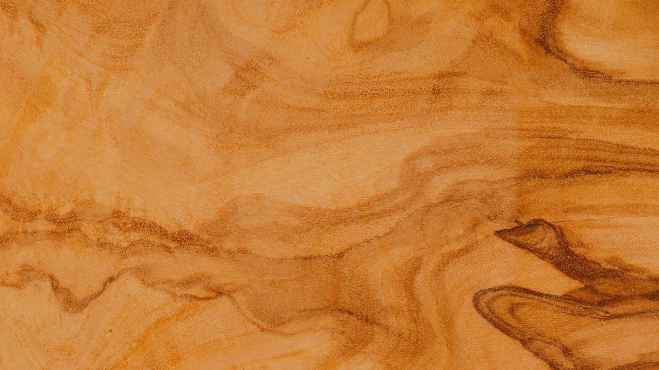 A Peanut Butter protein bar is pictured in front of a swirling rock texture is which has been treated with a yellowy color to hint to the bar’s creamy peanut butter flavor.